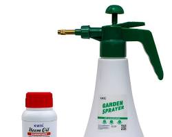 Bottle of neem oil and a sprayer for creating a soil drench to kill fungus gnats.